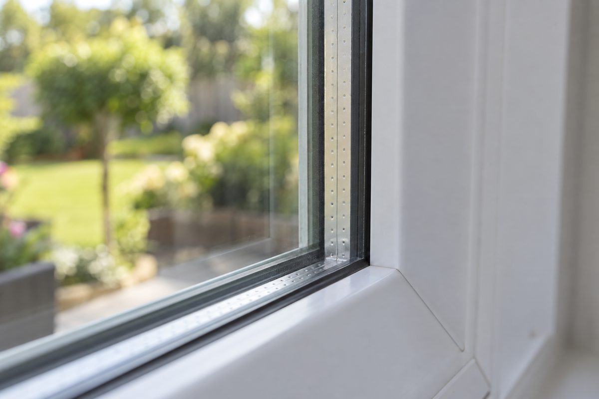 Close-up of the edge of a double-pane window showing the two panes and the spacer between them