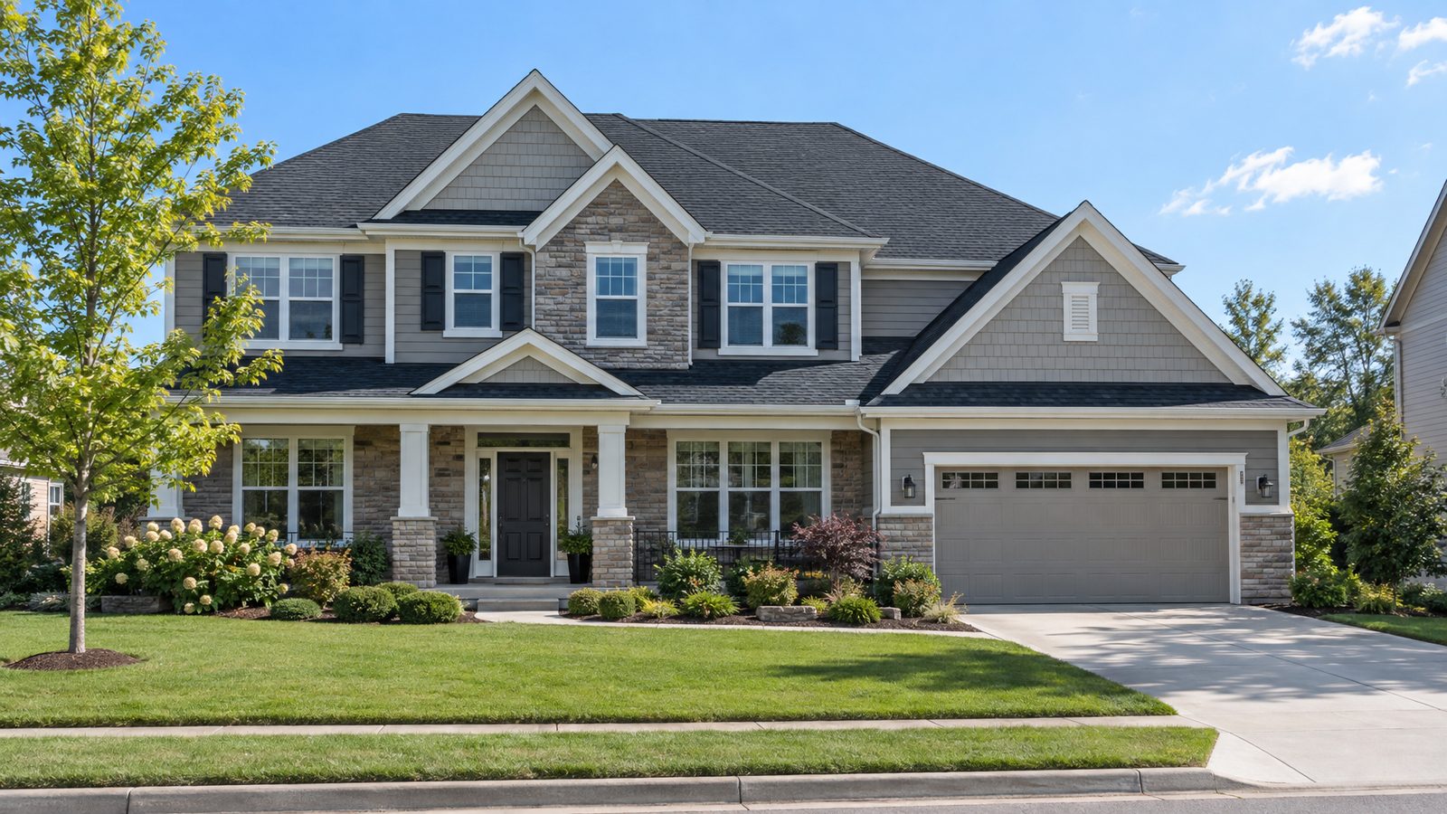 A suburban home with a charcoal shingle roof